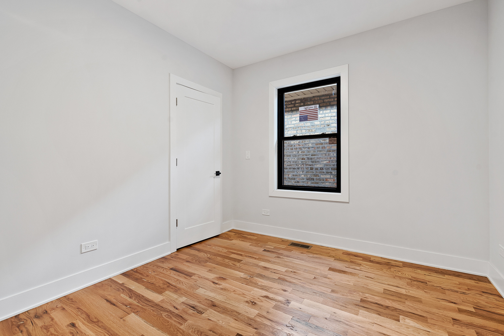 3529 North Nottingham Avenue Chicago, IL 60634 - Photo 14 of 33 an empty room with wooden floor and windows