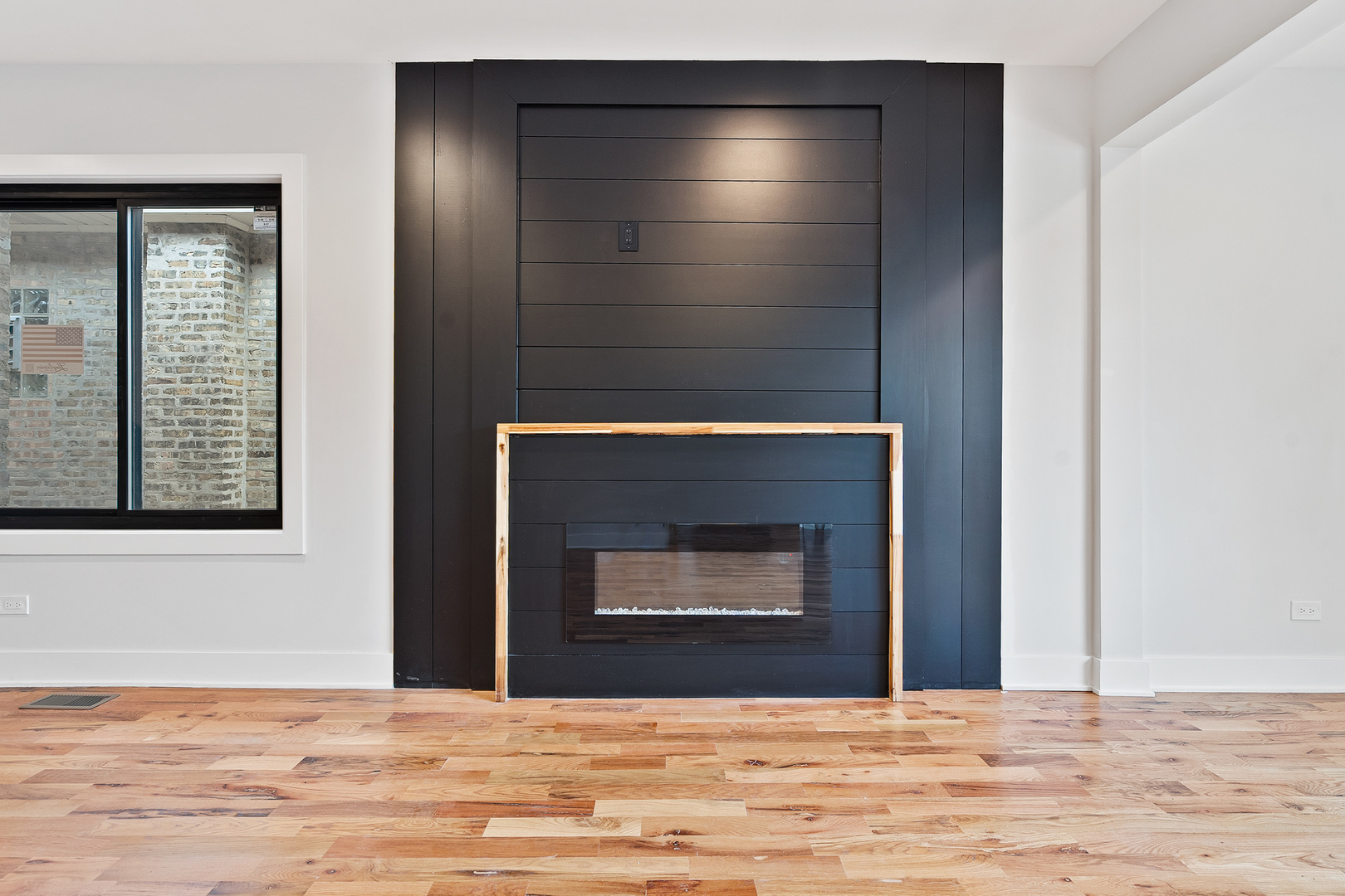 3529 North Nottingham Avenue Chicago, IL 60634 - Photo 5 of 33 a view of empty room with wooden floor and fireplace