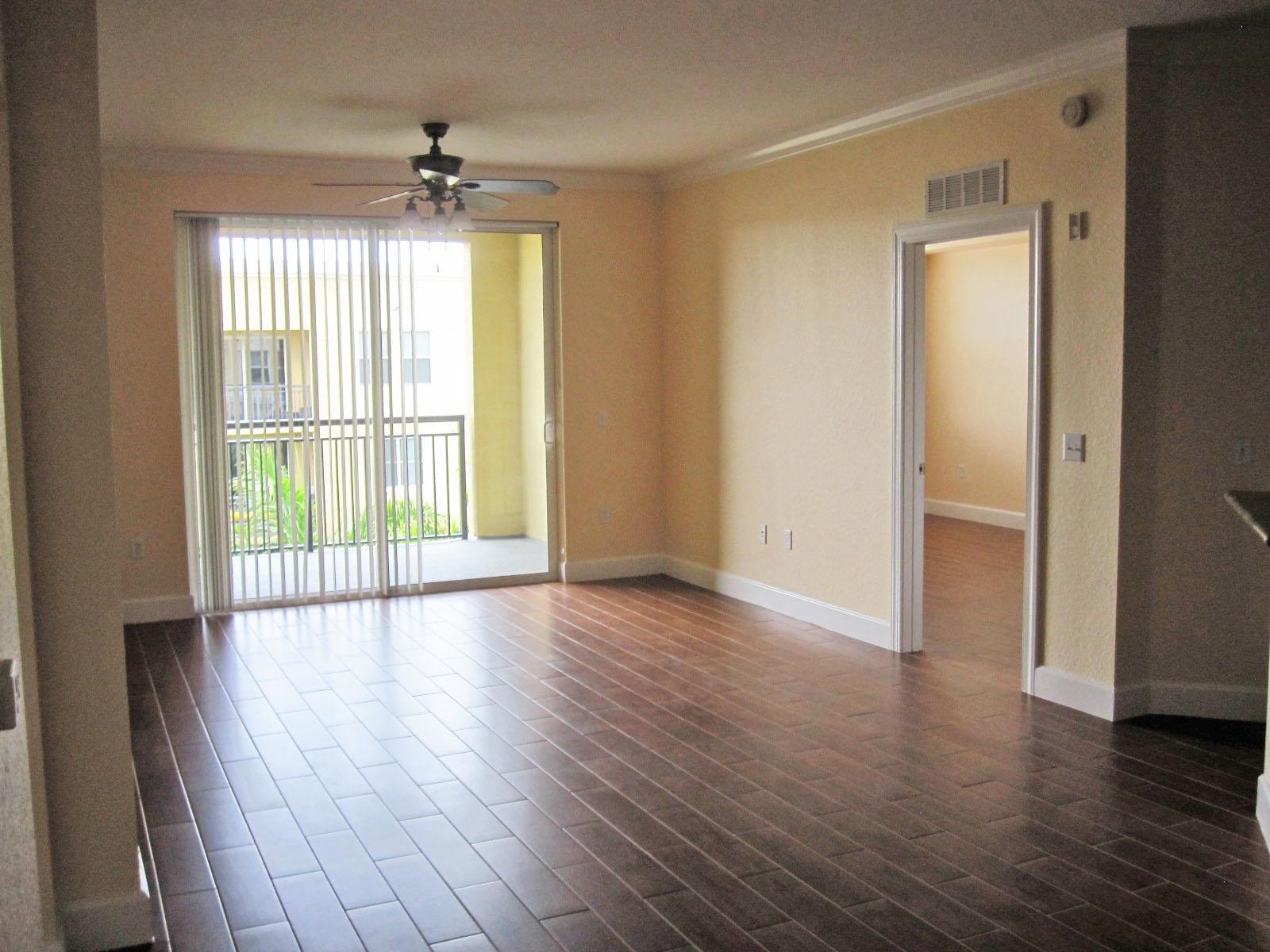 1690 Renaissance Commons Boulevard, Unit 1629 Boynton Beach, FL 33426 - Photo 3 of 18 wooden floor in an empty room with a window