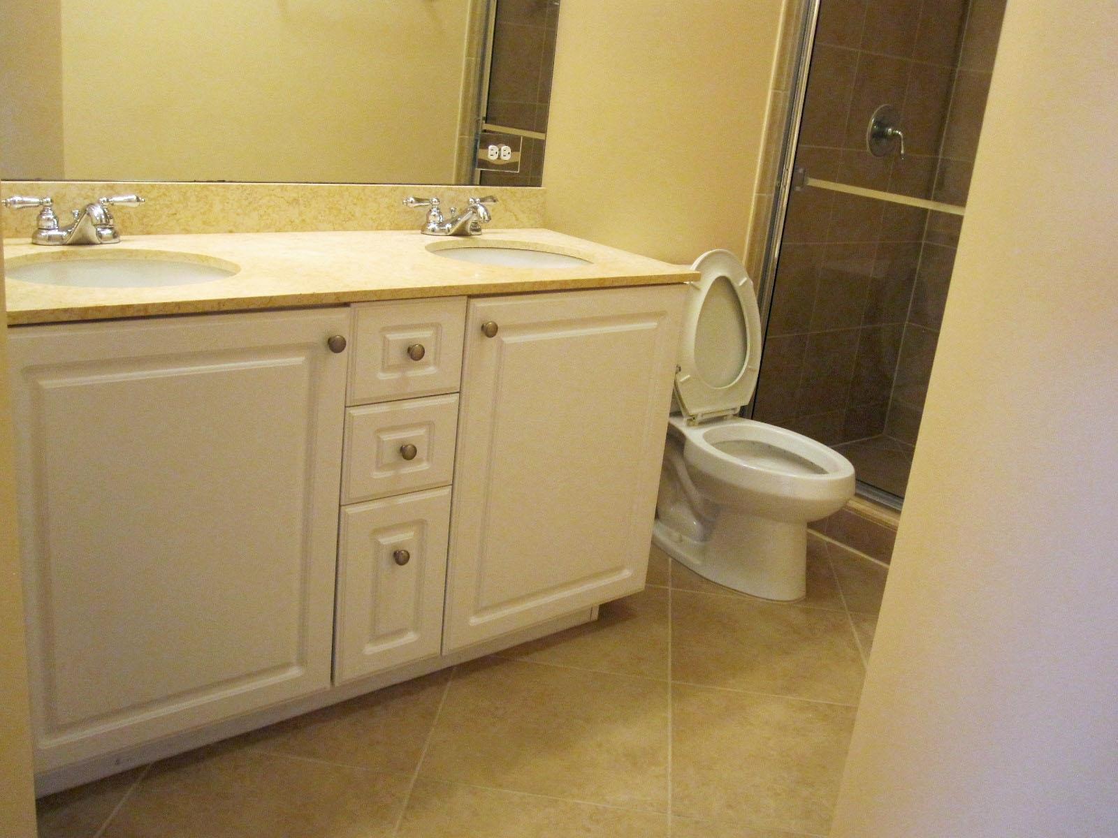 1690 Renaissance Commons Boulevard, Unit 1629 Boynton Beach, FL 33426 - Photo 6 of 18 a bathroom with a sink a toilet and shower