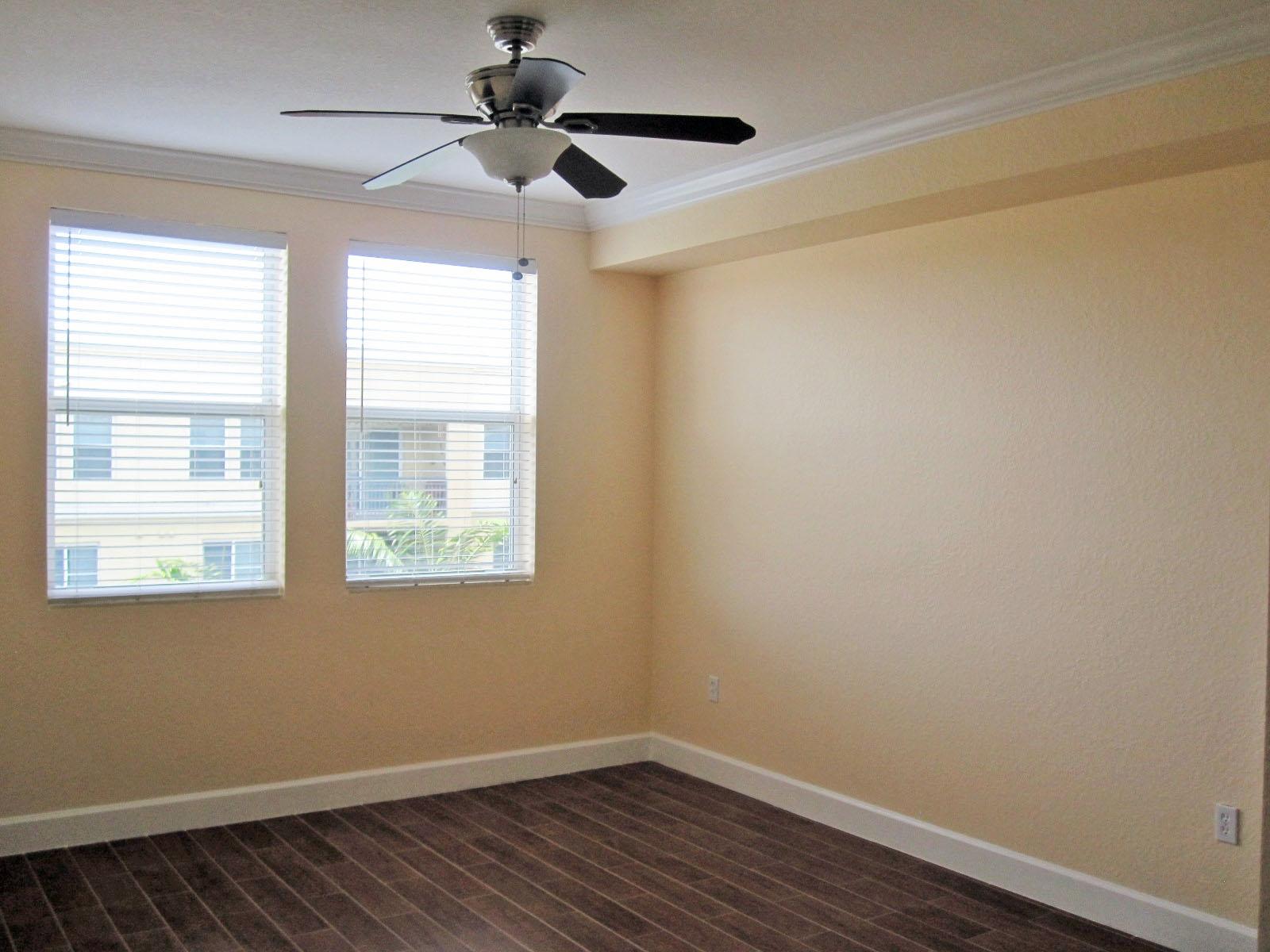 1690 Renaissance Commons Boulevard, Unit 1629 Boynton Beach, FL 33426 - Photo 8 of 18 a view of an empty room with wooden floor and a window