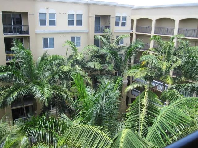 a view of a brick building next to a yard