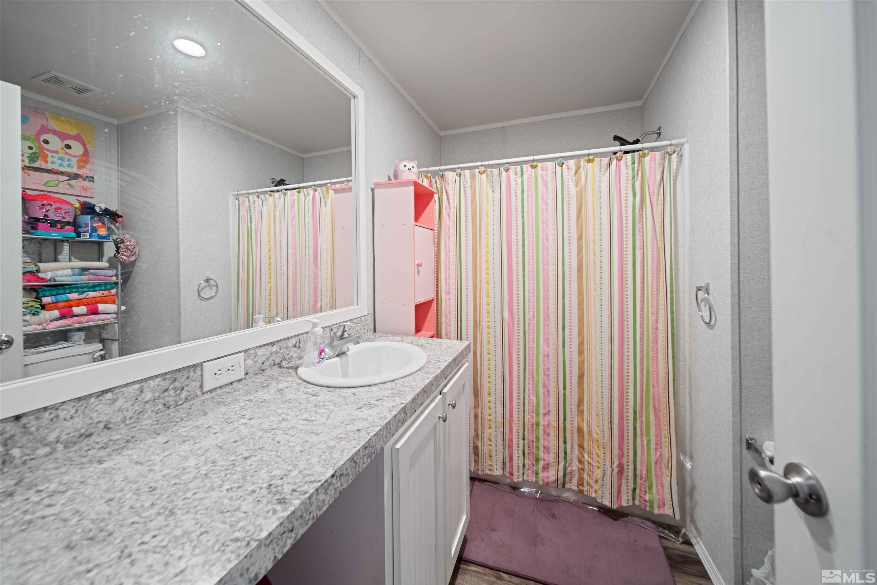 4020 Grouse Way Reno, NV 89508 - Photo 12 of 28 a bathroom with a granite countertop sink and a mirror