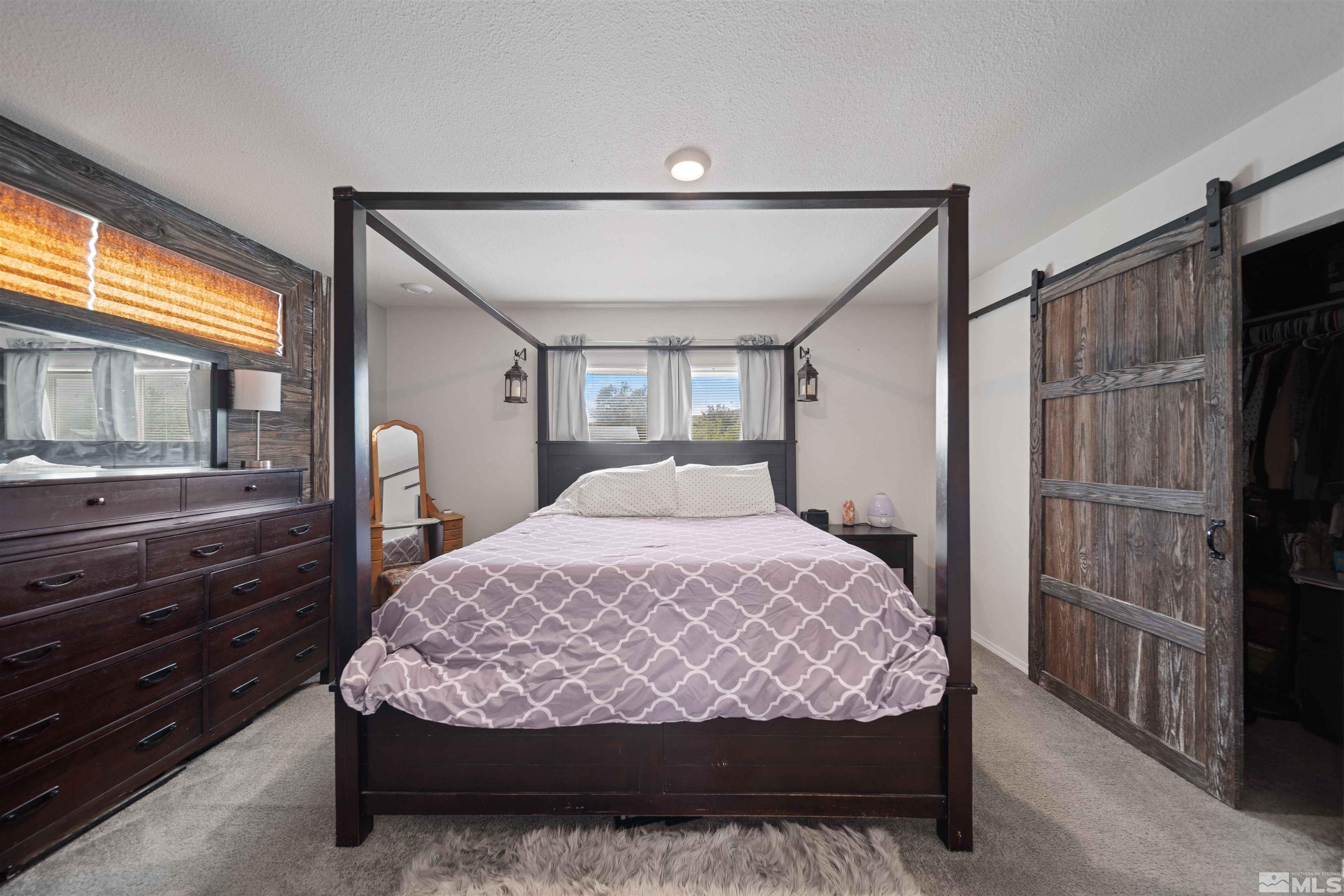4020 Grouse Way Reno, NV 89508 - Photo 18 of 28 a bed sitting in a room next to a window
