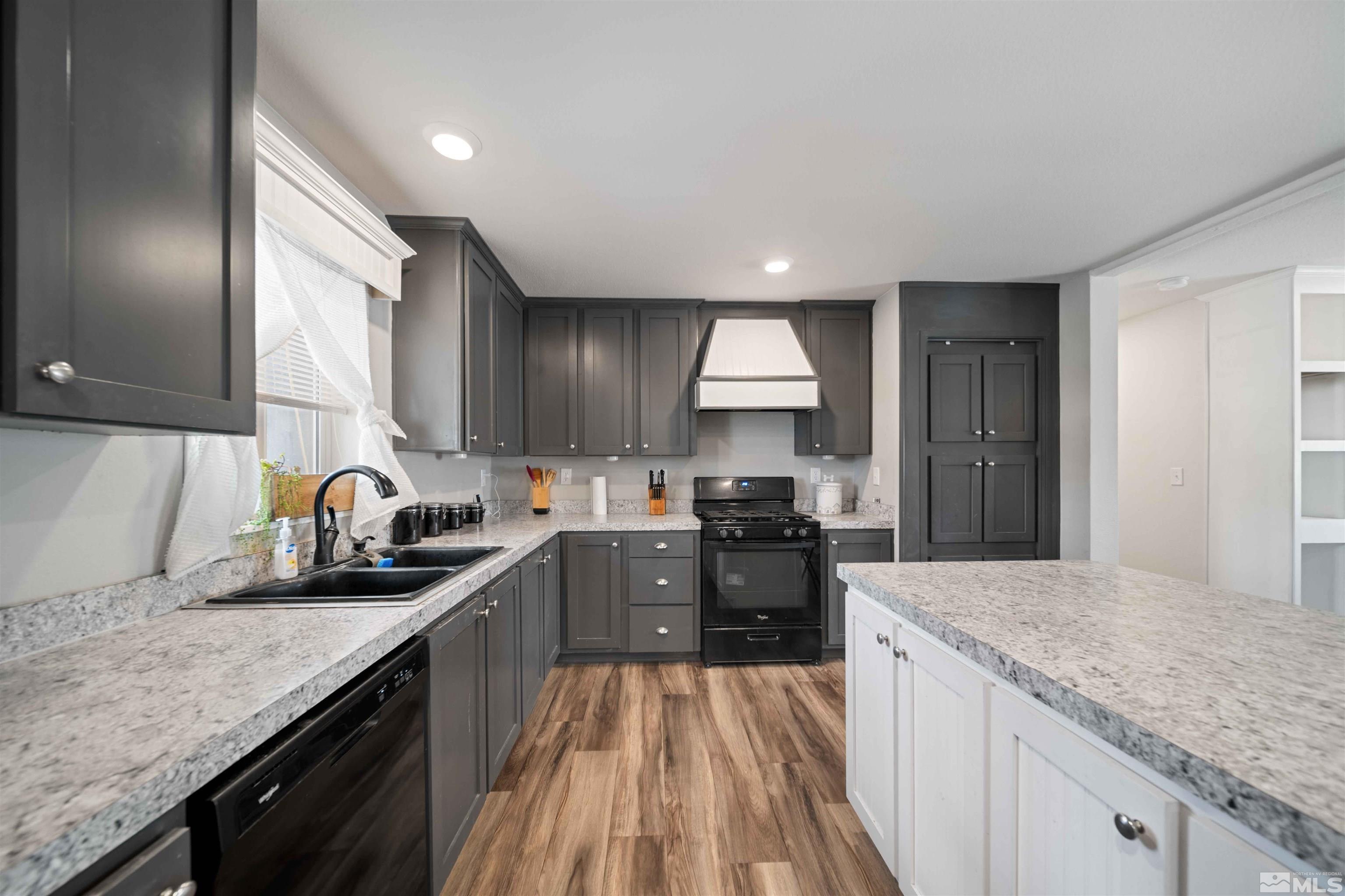 4020 Grouse Way Reno, NV 89508 - Photo 3 of 28 a kitchen with granite countertop a sink a counter space appliances and cabinets
