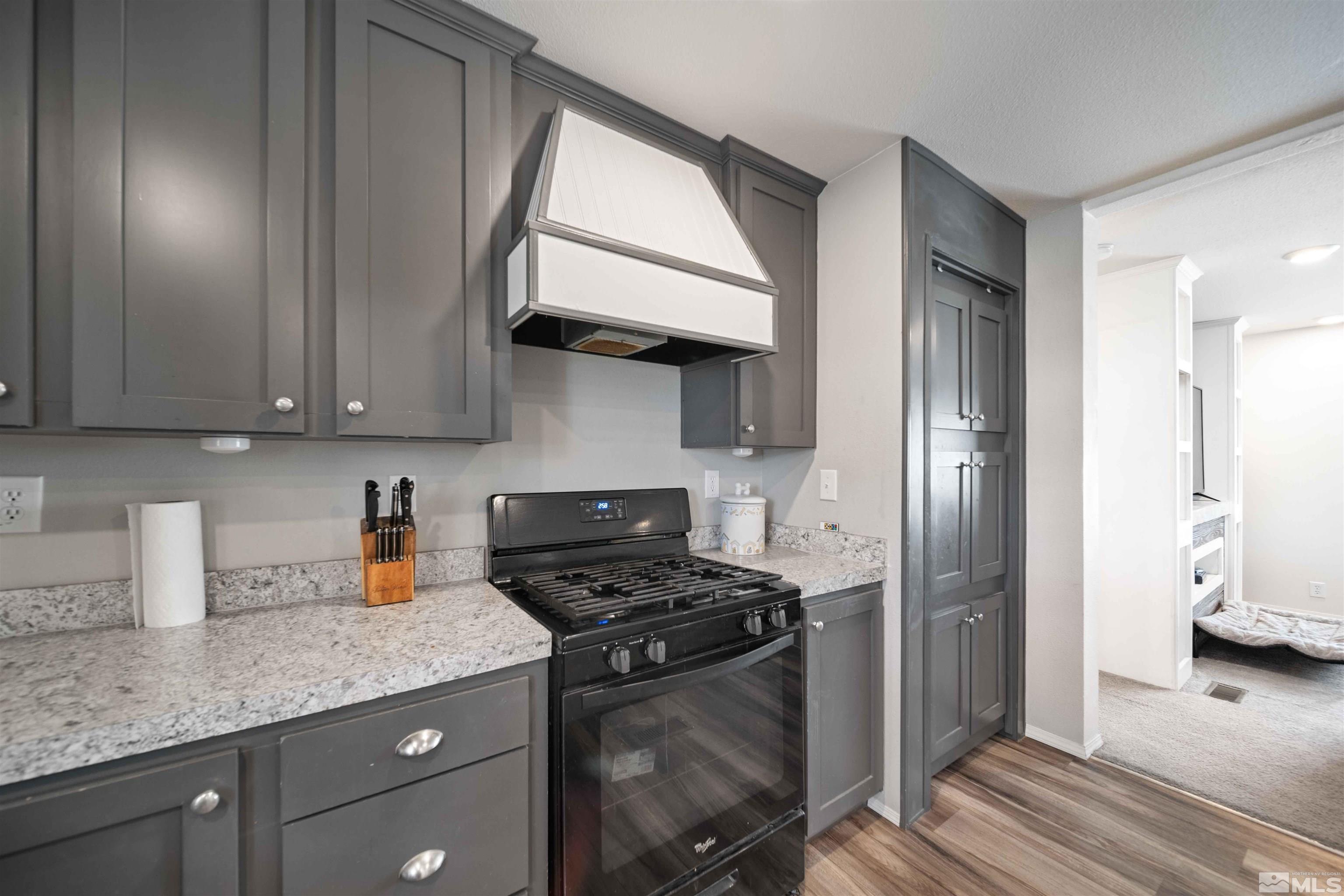4020 Grouse Way Reno, NV 89508 - Photo 5 of 28 a kitchen with stainless steel appliances granite countertop a stove a refrigerator and a cabinets