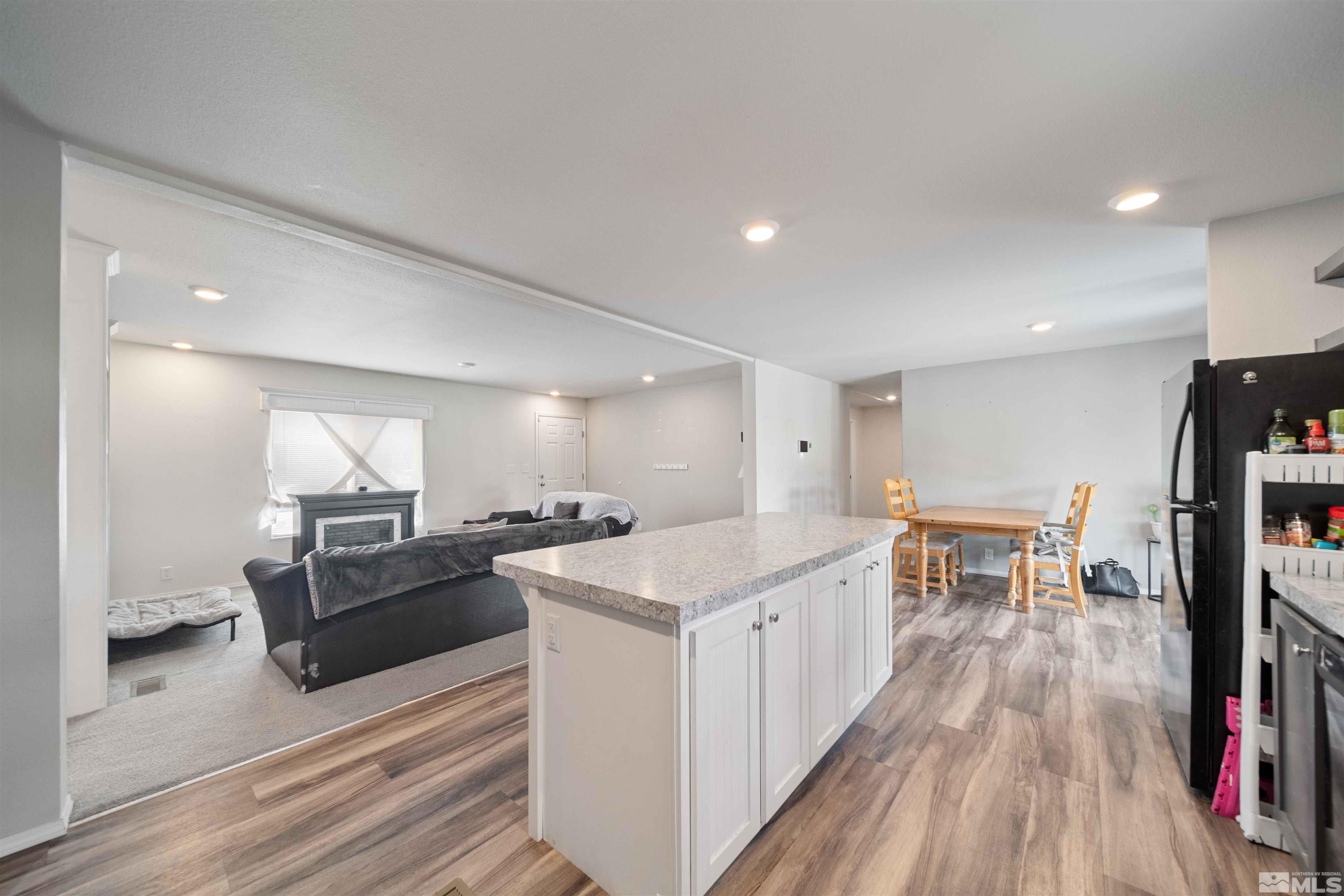 4020 Grouse Way Reno, NV 89508 - Photo 6 of 28 a open kitchen with stainless steel appliances granite countertop a lot of cabinets and wooden floor