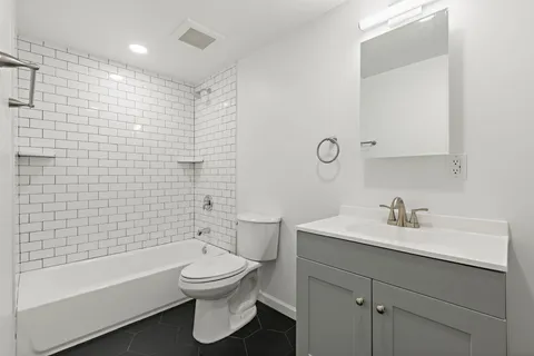 an empty room with a workbench and a window