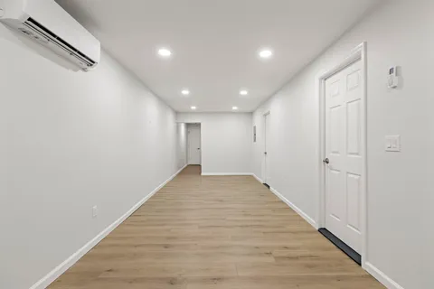 a view of a hallway with wooden floor