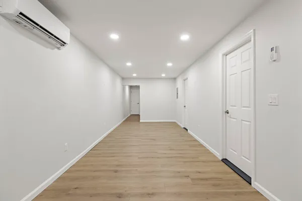 a view of a hallway with wooden floor