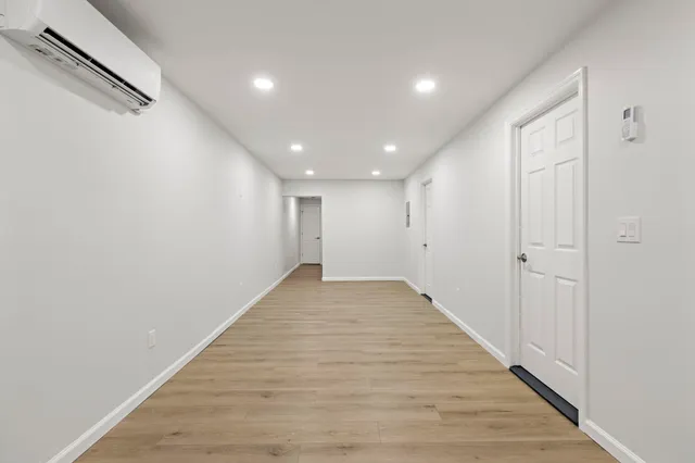 a view of a hallway with wooden floor