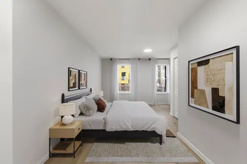 a bedroom with a bed and a chair