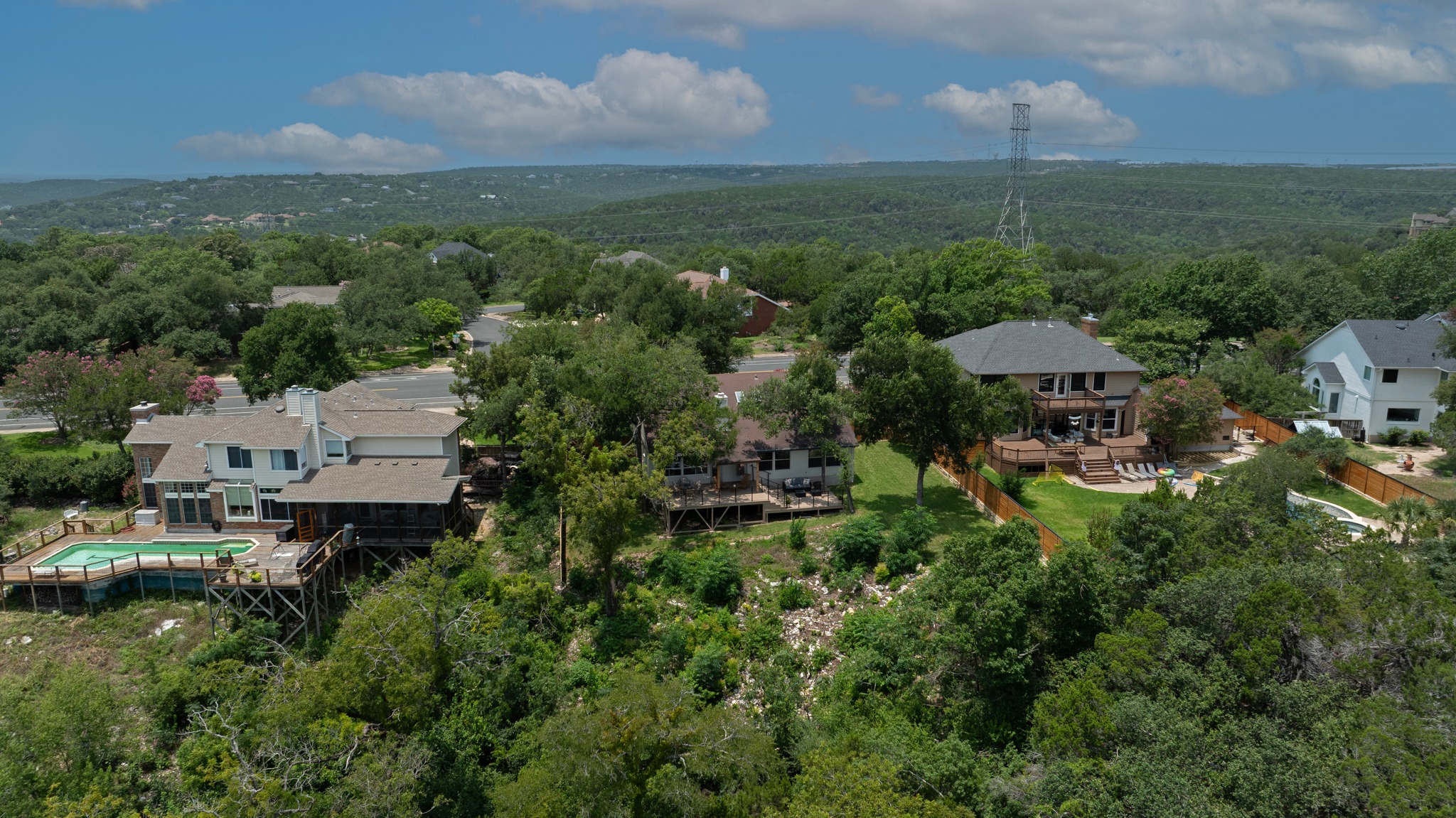 7705 Jester Boulevard Austin, TX 78730 - Photo 29 of 36 Hillside homes surrounded by dense greenery offer private outdoor living and scenic vistas.