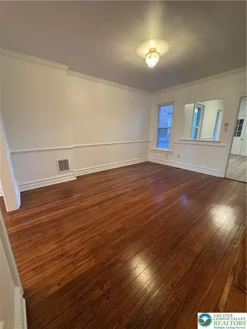a view of room with window and wooden floor
