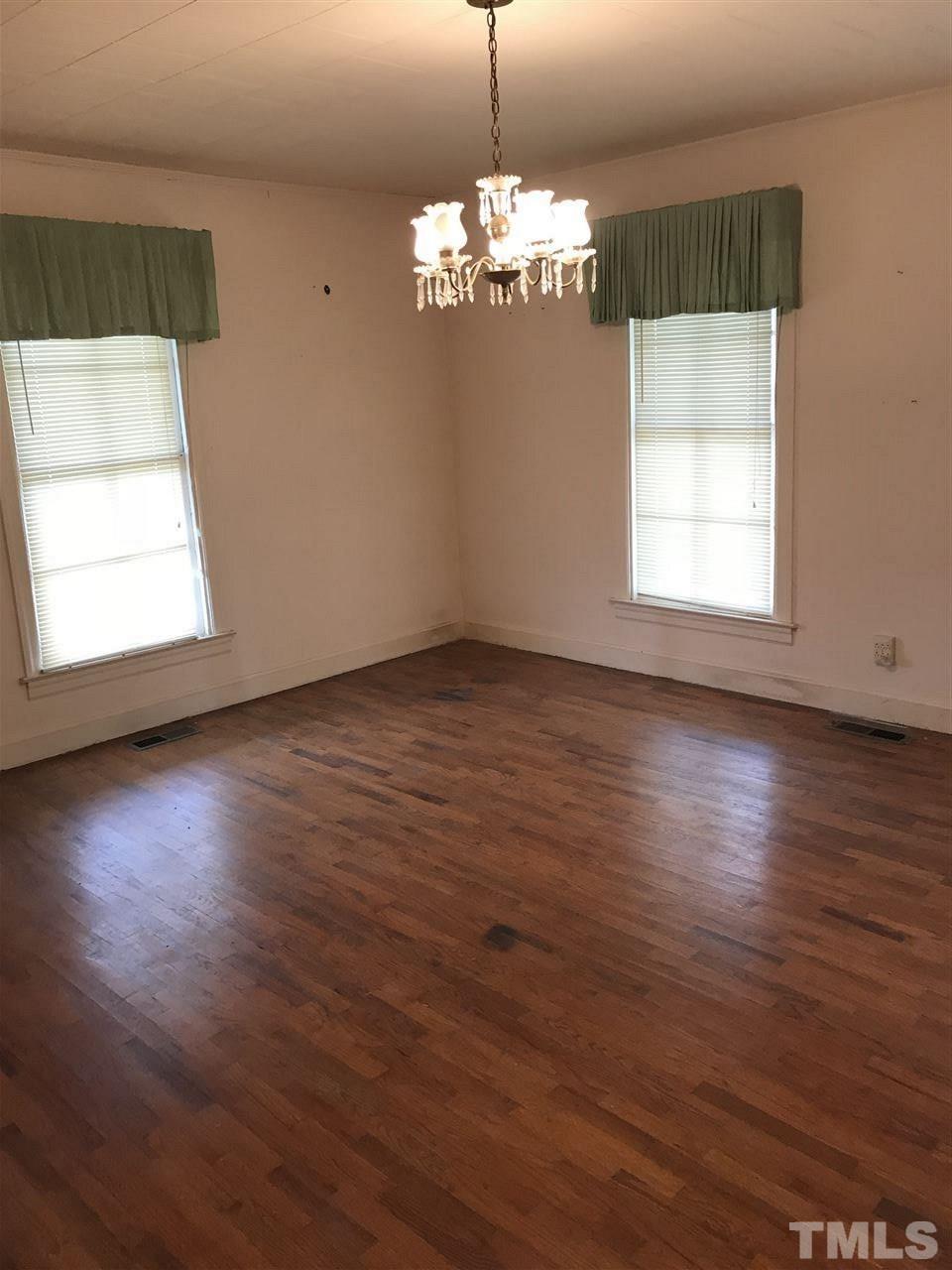 6186 Fairground Road Dunn, NC 28334 - Photo 14 of 19 an empty room with wooden floor and windows