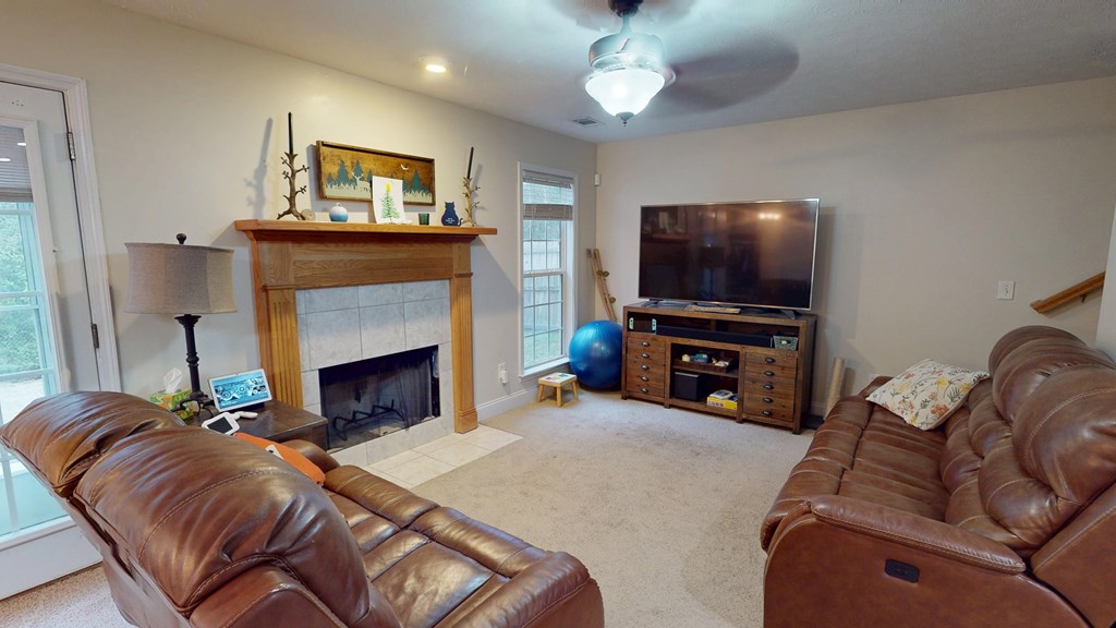 5260 Kingsberry Lane Columbus, GA 31907 - Photo 2 of 23 a living room with furniture a flat screen tv and a fireplace
