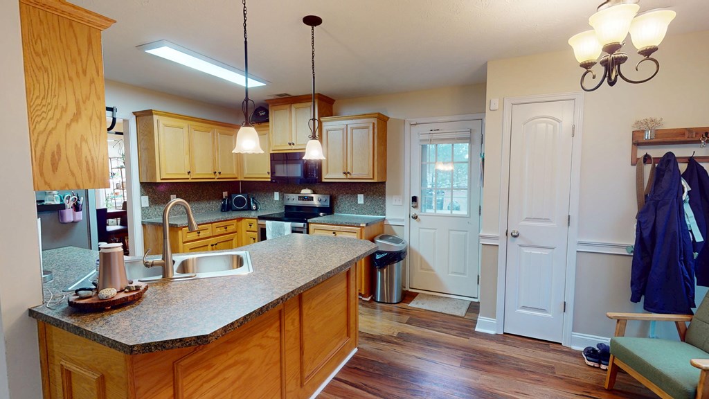 5260 Kingsberry Lane Columbus, GA 31907 - Photo 3 of 23 a kitchen with stainless steel appliances granite countertop a sink a stove and a wooden floors