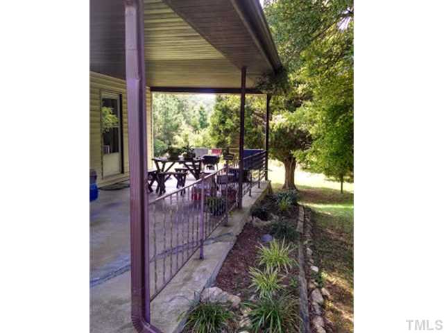 2226 Ellis Chapel Road Bahama, NC 27503 - Photo 3 of 22 The carport makes a wonderful covered patio space.
