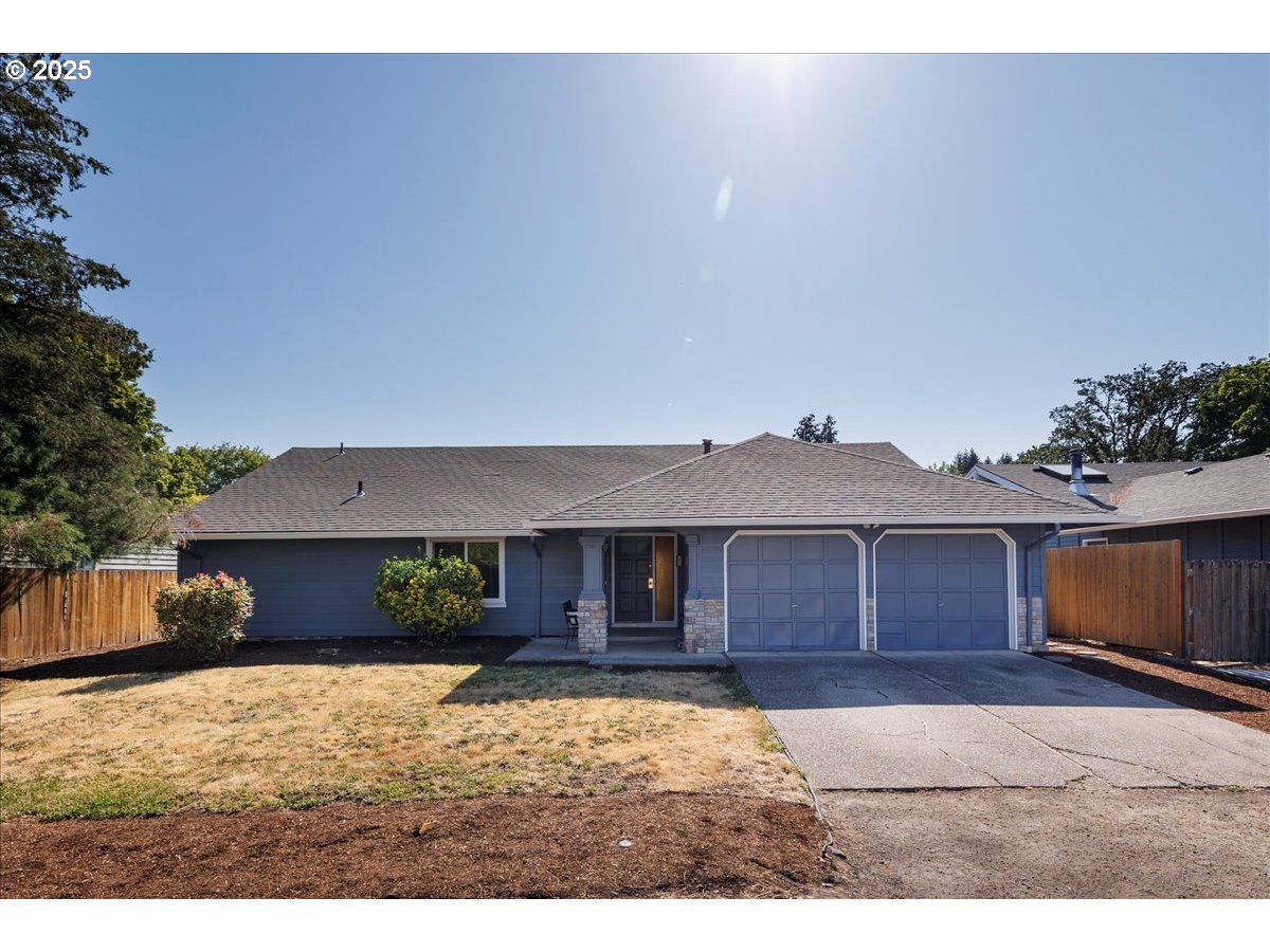 2610 Southwest 204th Avenue Beaverton, OR 97003 - Photo 1 of 37 a front view of a house with a yard and garage