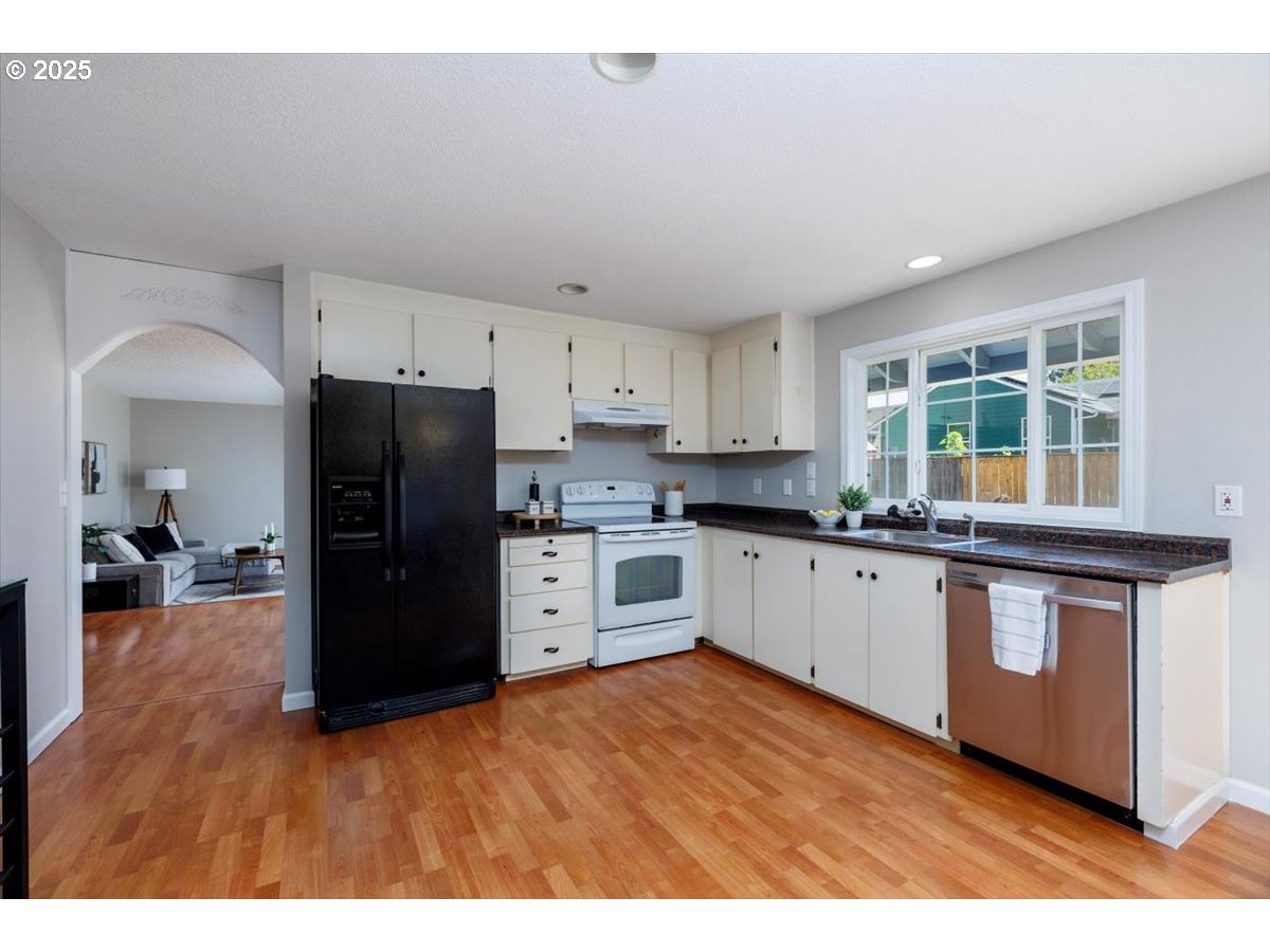 2610 Southwest 204th Avenue Beaverton, OR 97003 - Photo 11 of 37 a kitchen with stainless steel appliances granite countertop a refrigerator a stove a sink and a microwave
