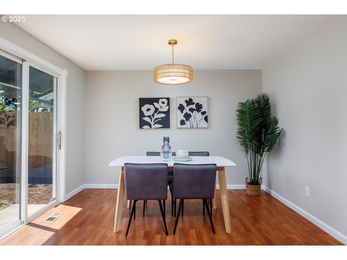 2610 Southwest 204th Avenue Beaverton, OR 97003 - Photo 13 of 37 a view of a dining room with furniture window and wooden floor