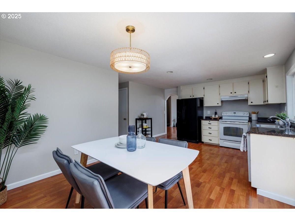 2610 Southwest 204th Avenue Beaverton, OR 97003 - Photo 14 of 37 a kitchen with a table chairs and refrigerator