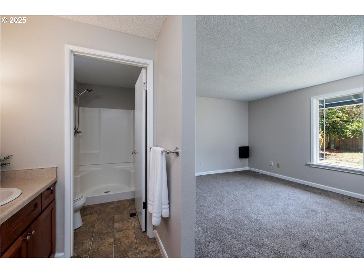 2610 Southwest 204th Avenue Beaverton, OR 97003 - Photo 18 of 37 a view of an empty room with a bathroom and a window