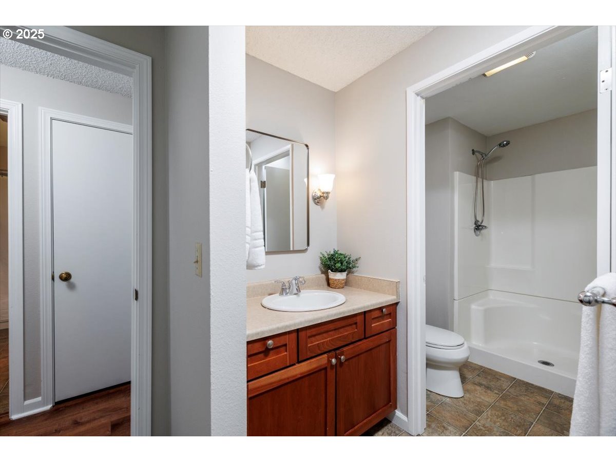 2610 Southwest 204th Avenue Beaverton, OR 97003 - Photo 19 of 37 a bathroom with a sink a toilet and shower