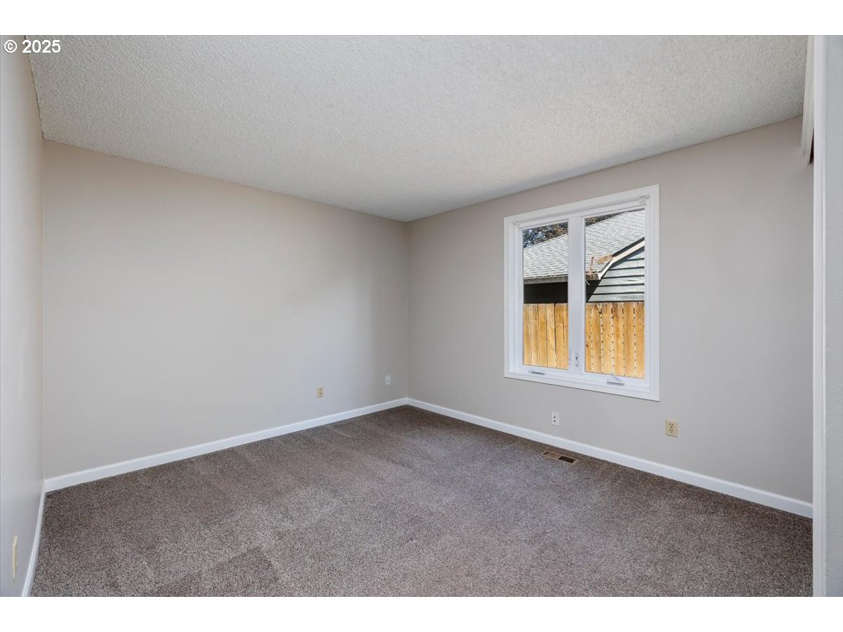 2610 Southwest 204th Avenue Beaverton, OR 97003 - Photo 24 of 37 a view of an empty room with a window
