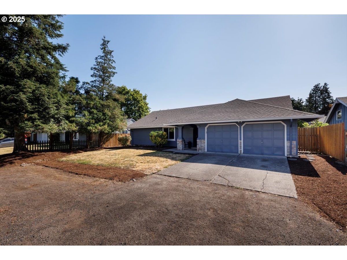 2610 Southwest 204th Avenue Beaverton, OR 97003 - Photo 3 of 37 a front view of a house with a yard and garage