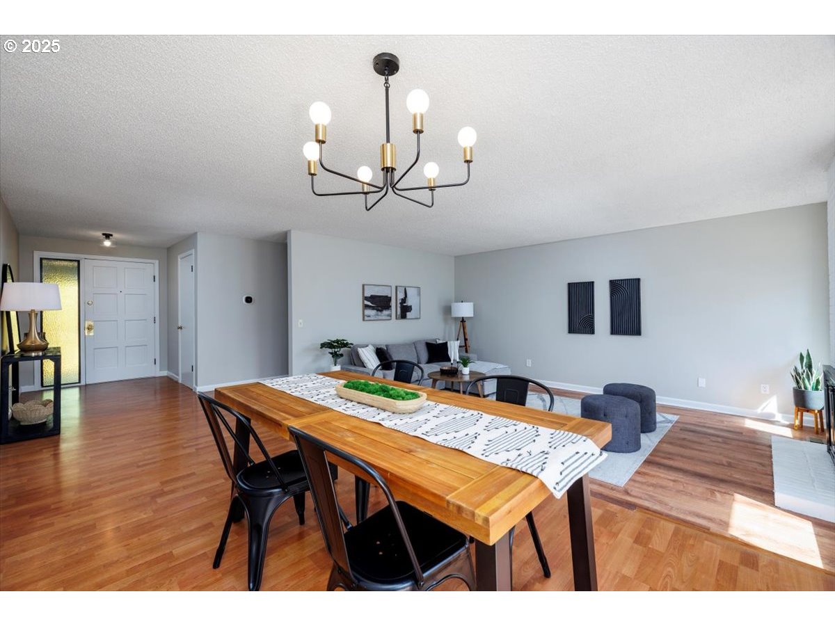 2610 Southwest 204th Avenue Beaverton, OR 97003 - Photo 7 of 37 a view of a dining room with furniture and wooden floor