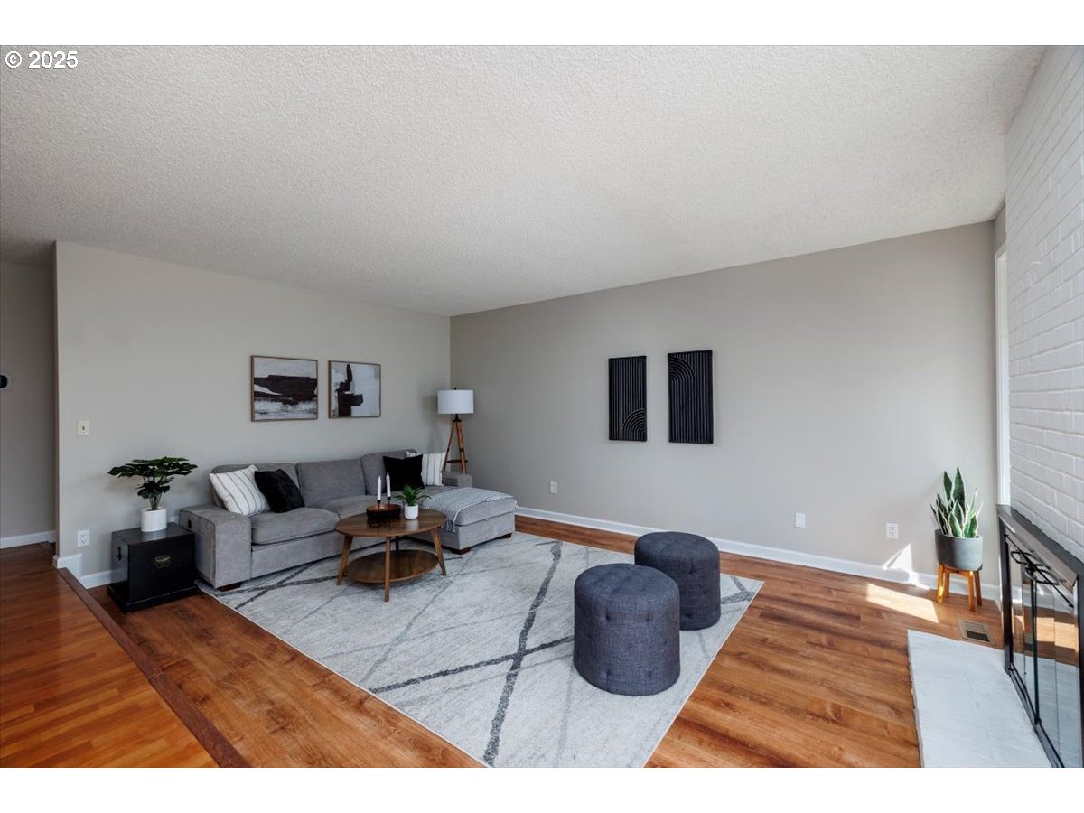 2610 Southwest 204th Avenue Beaverton, OR 97003 - Photo 9 of 37 a living room with furniture and a rug
