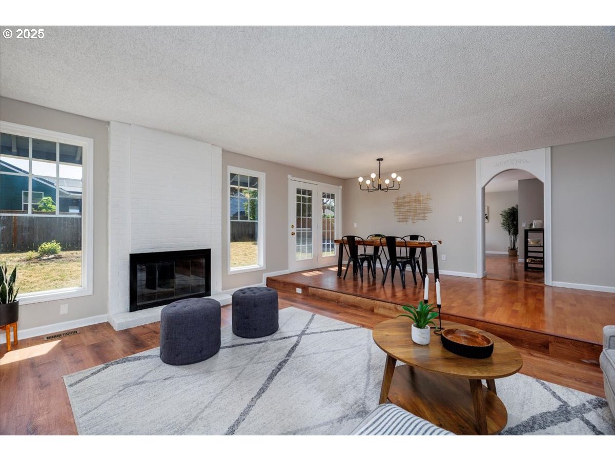 2610 Southwest 204th Avenue Beaverton, OR 97003 - Photo 10 of 37 a living room with furniture a fireplace and a table