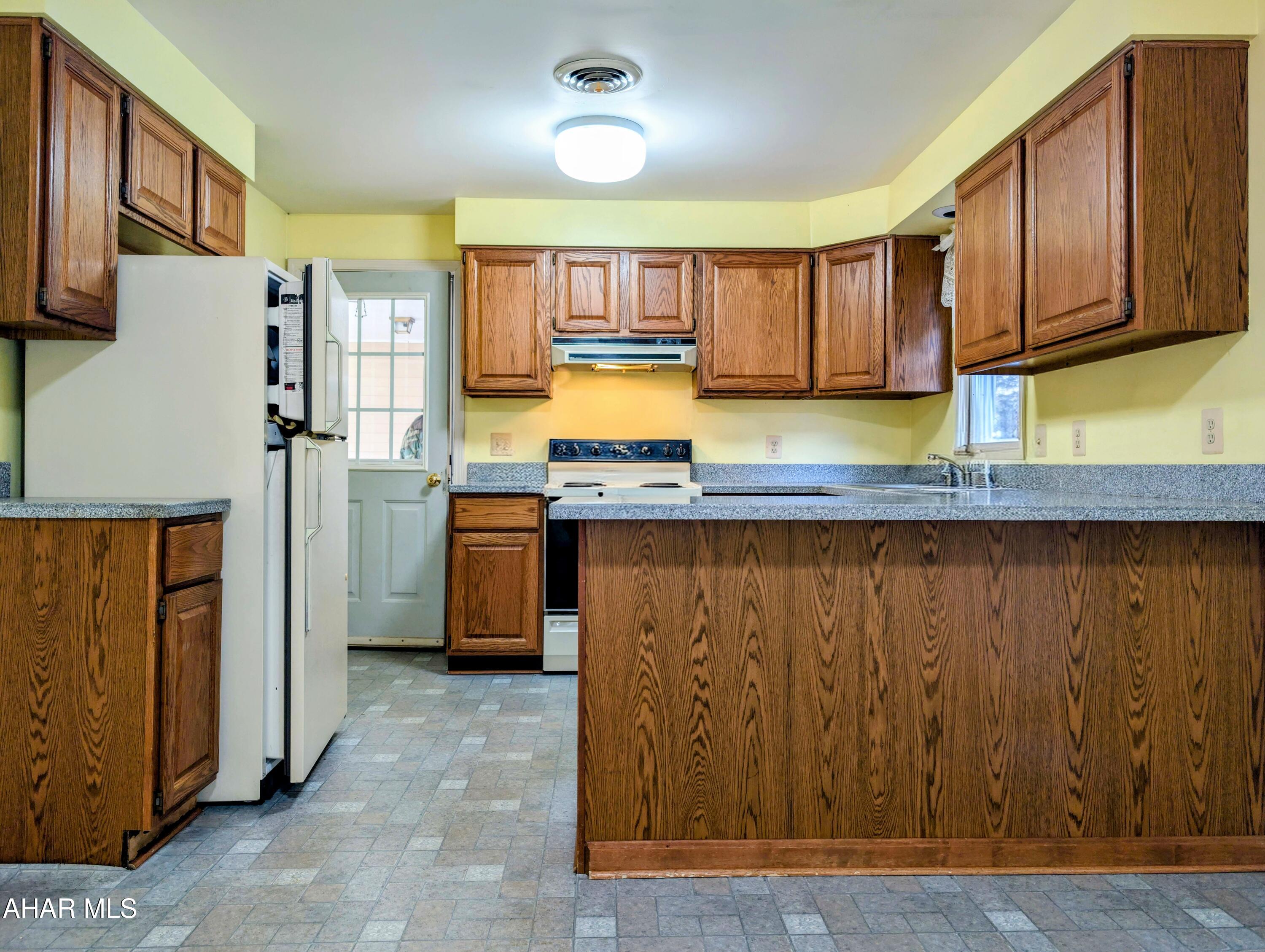 147 Pine Street Hyndman, PA 15545 - Photo 7 of 44 a kitchen with stainless steel appliances granite countertop a stove a sink and a refrigerator