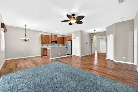 a view of kitchen and hall with wooden floor
