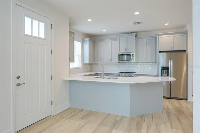 a bathroom with a shower sink vanity mirror and toilet
