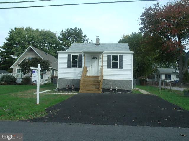 7350 Chesapeake Road Middle River, MD 21220 - Photo 16 of 21 a front view of a house with a yard and garage
