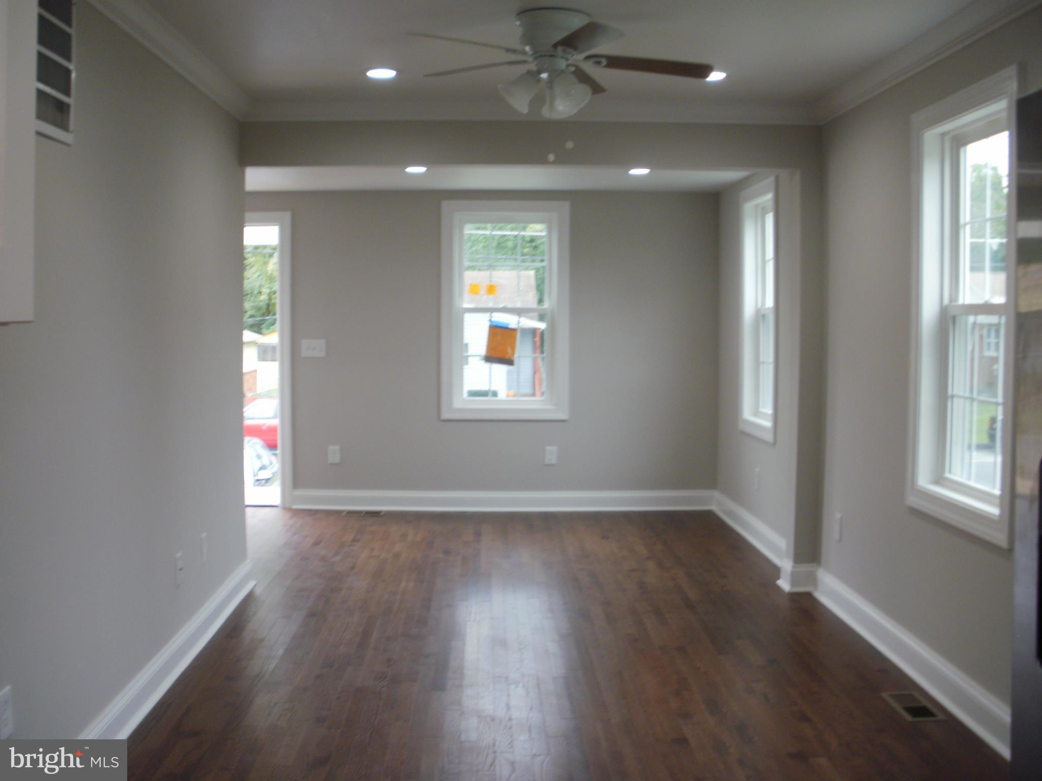 7350 Chesapeake Road Middle River, MD 21220 - Photo 3 of 21 an empty room with wooden floor and windows
