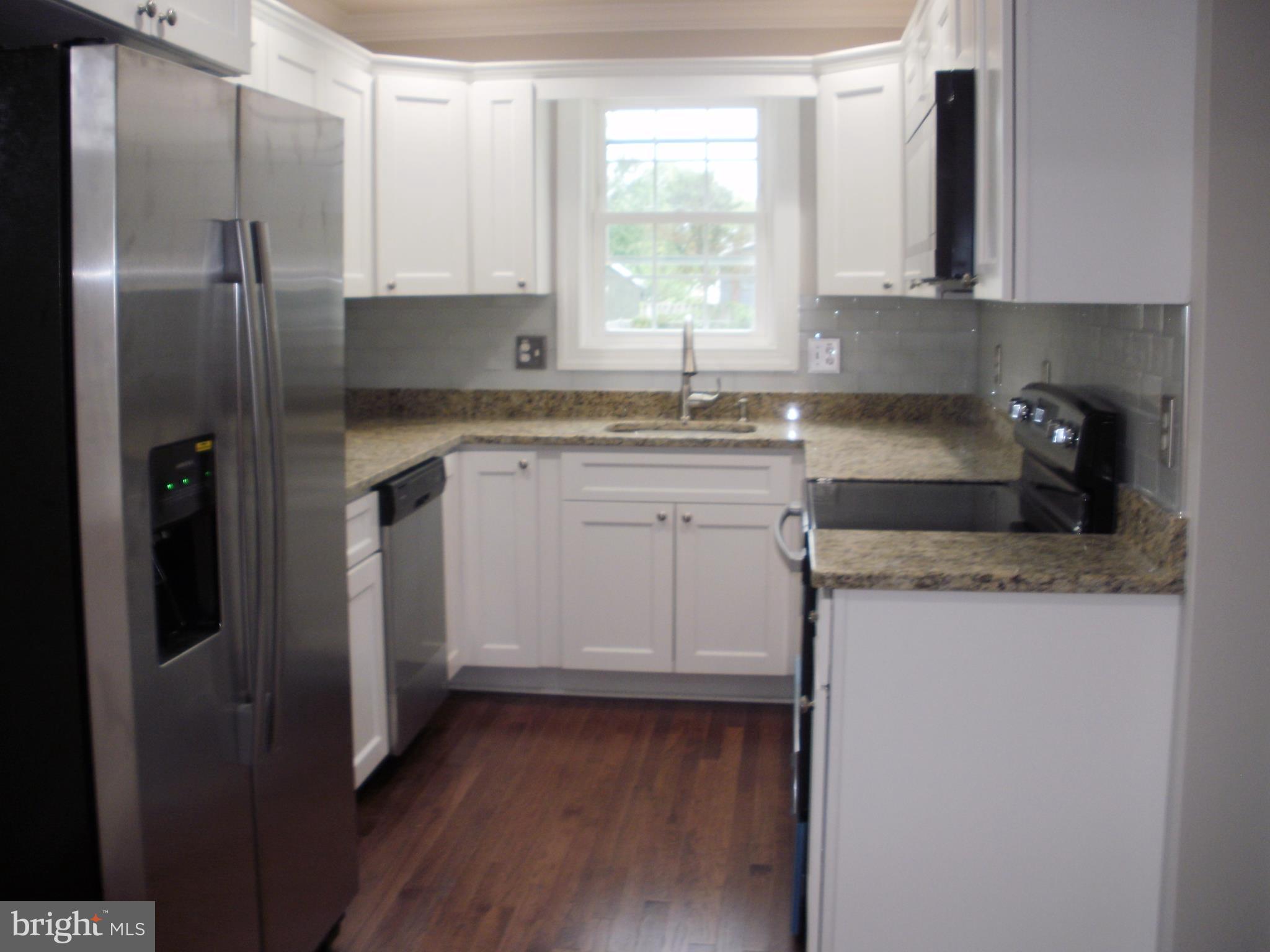 7350 Chesapeake Road Middle River, MD 21220 - Photo 4 of 21 a kitchen with stainless steel appliances granite countertop a refrigerator sink and microwave