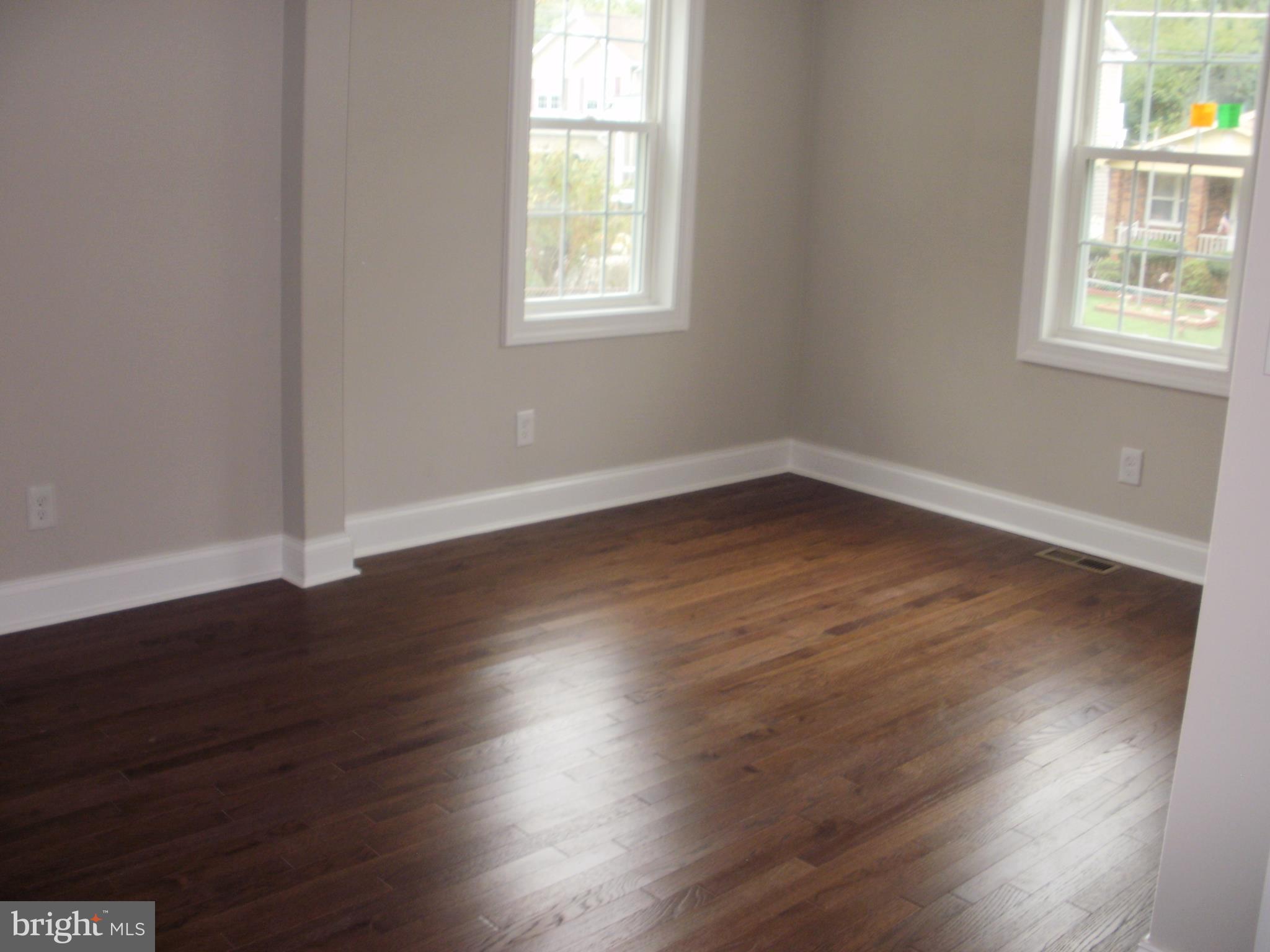7350 Chesapeake Road Middle River, MD 21220 - Photo 5 of 21 an empty room with wooden floor and windows