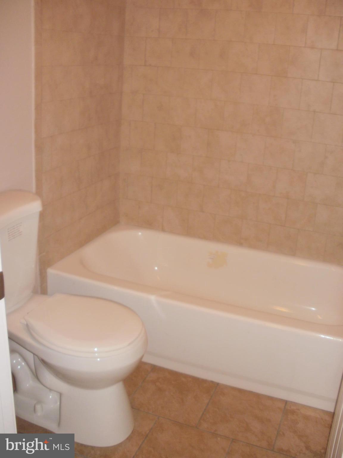 7350 Chesapeake Road Middle River, MD 21220 - Photo 7 of 21 a white toilet sitting next to a bath tub
