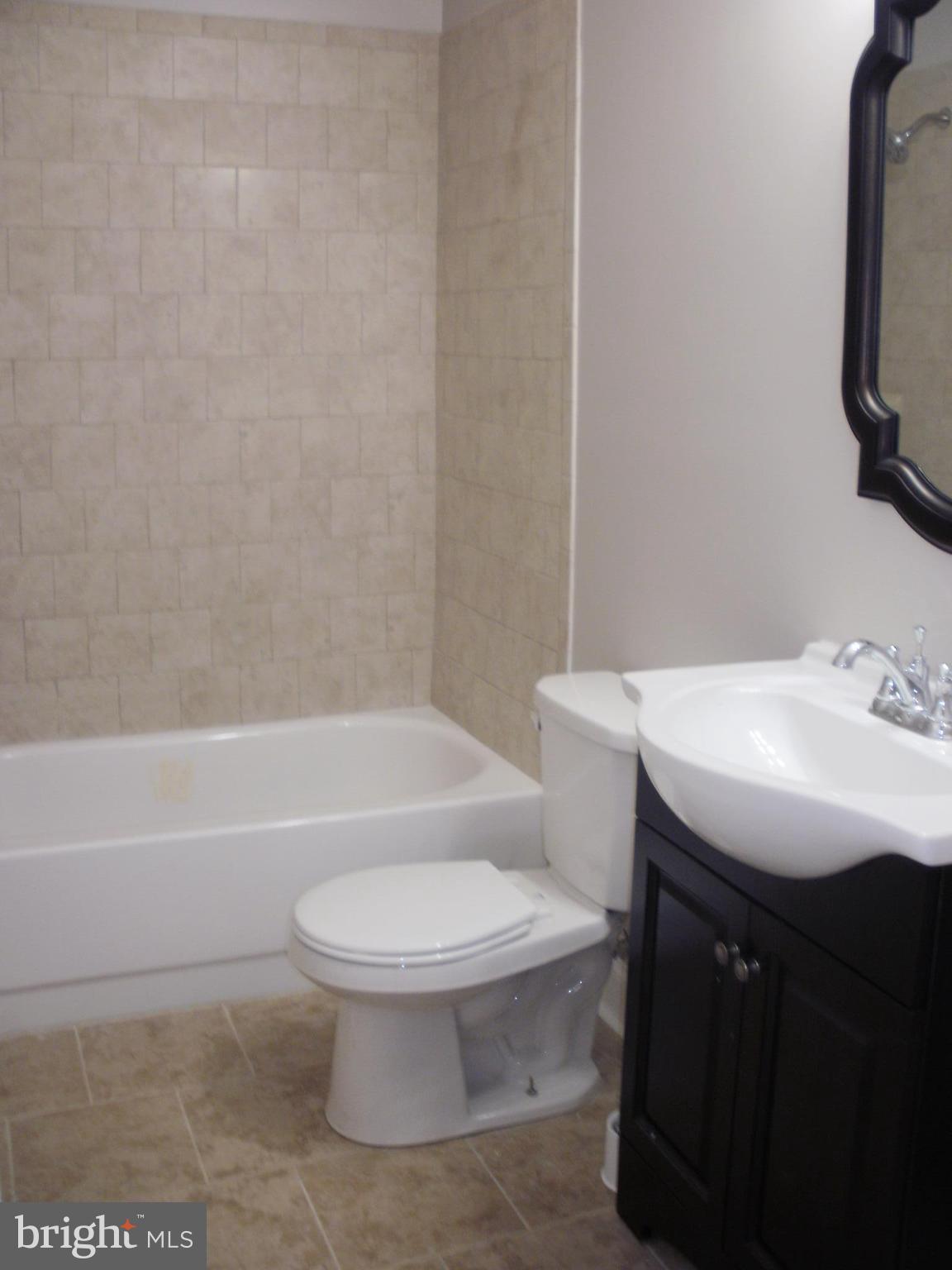 7350 Chesapeake Road Middle River, MD 21220 - Photo 8 of 21 a bathroom with a sink toilet and a bathtub