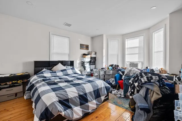 a bed room with two beds and a large window