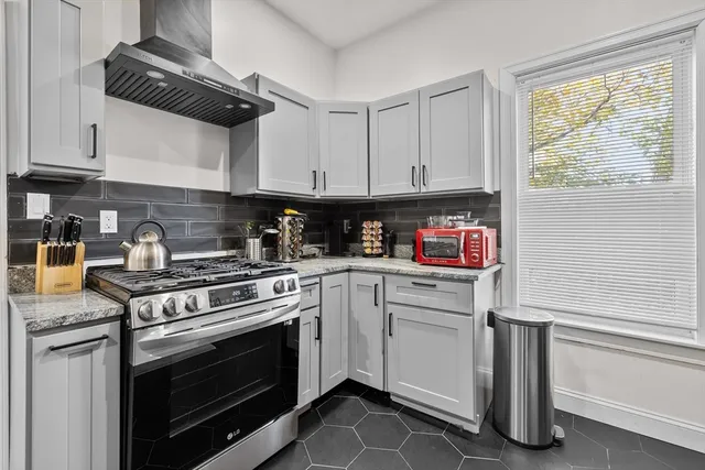 a kitchen with cabinets appliances and a window