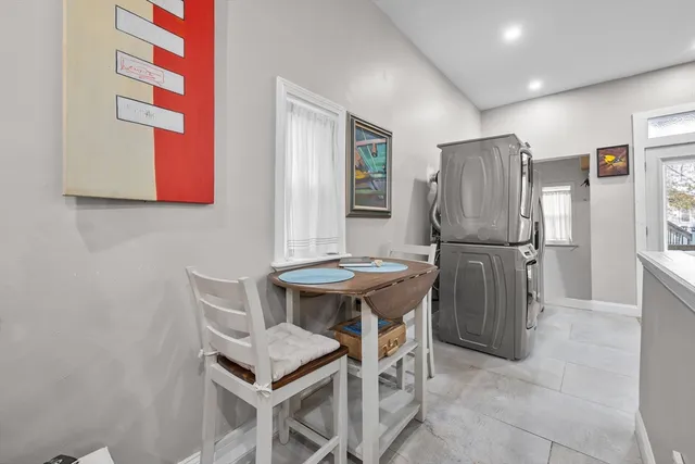 a kitchen with stainless steel appliances refrigerator dining table and chairs