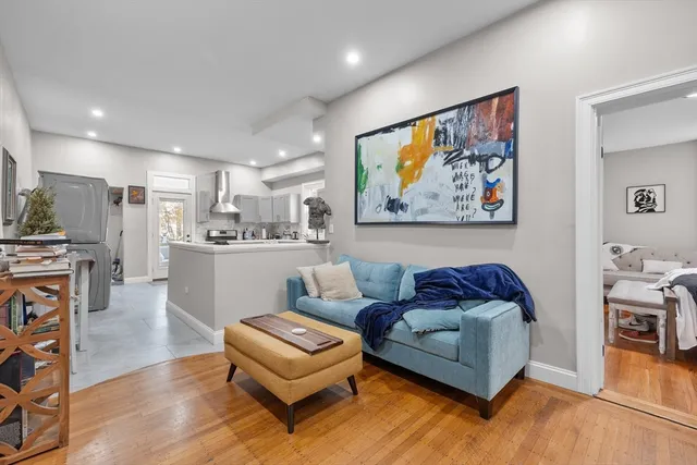 a living room with furniture and kitchen view