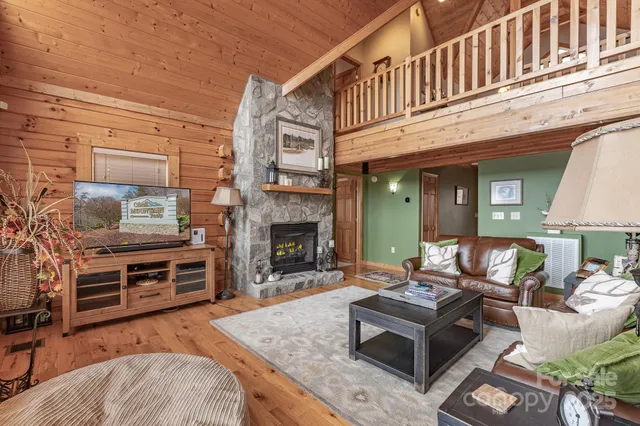 a living room with furniture a fireplace and a table