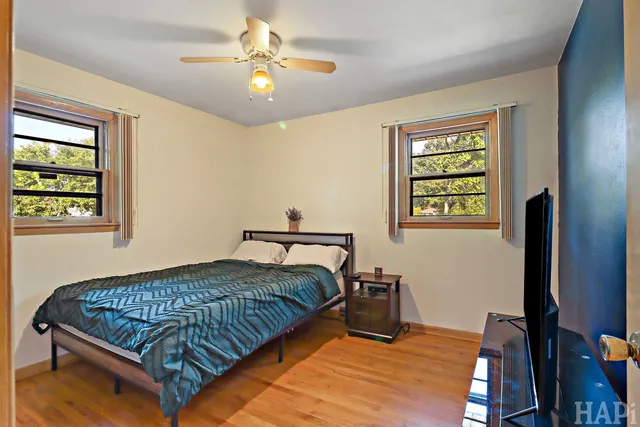 a bedroom with a bed wall painting and a window