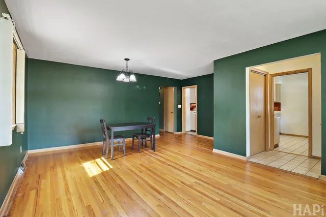a view of a livingroom with wooden floor and furniture