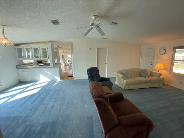 a spacious bedroom with a bed and a chandelier
